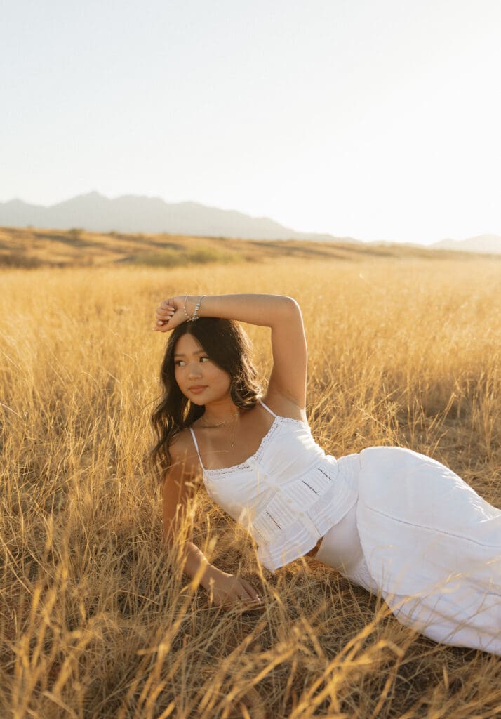 Photograph-of-high-school-senior-girl-laying-in-sonoita-arizona-field